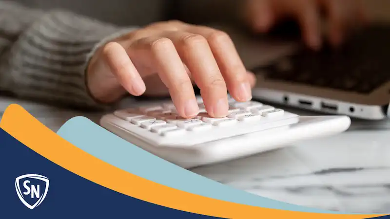 close up on the hand of an accountant analyzing numbers on a calculator
