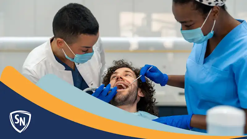 dental assistants working on a happy patient