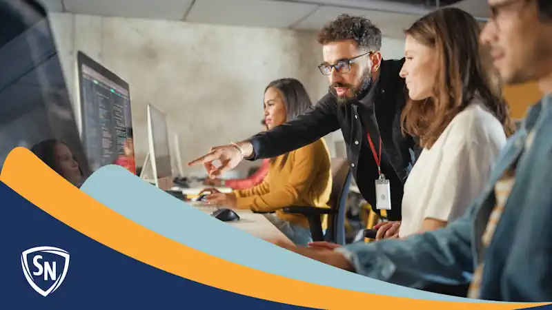 teacher teaching computer science students